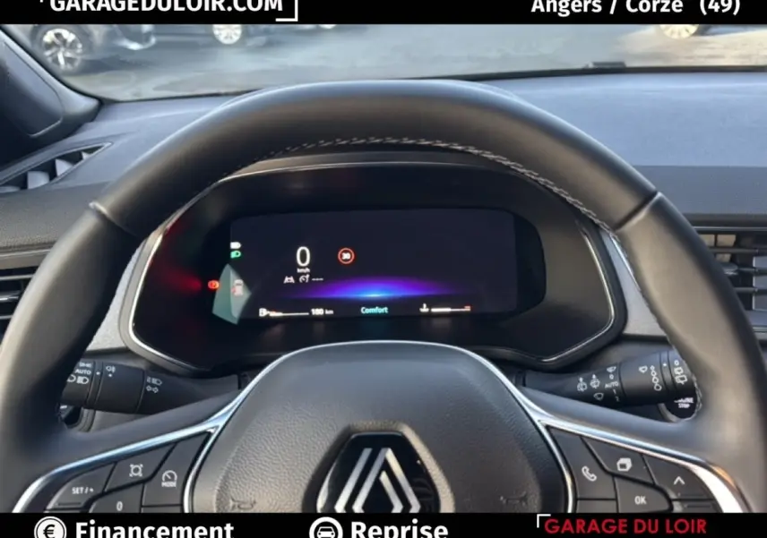 Vue intérieure centrée sur le volant et le tableau de bord numérique du Renault Captur techno TCe 90 gris foncé 2025.
