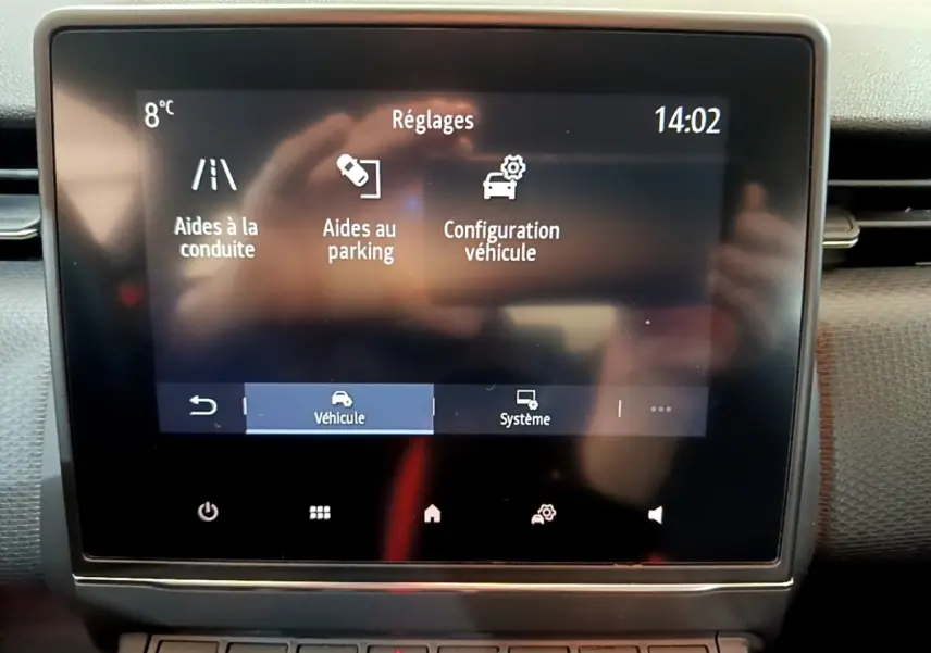 Écran tactile central affichant les réglages d'aides à la conduite et au parking dans une Renault Clio Business blanche.