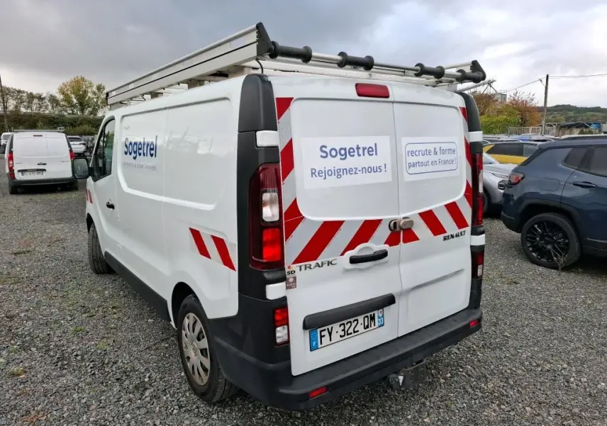 Vue 3/4 arrière droite du Renault Trafic blanc avec marquage Sogetrel et galerie sur le toit.