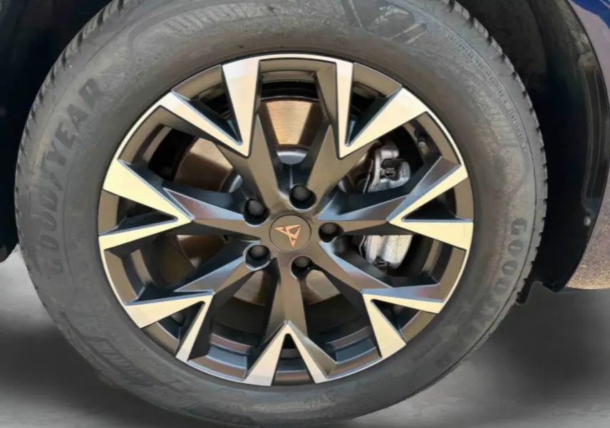 Gros plan sur la jante alliage bicolore avec logo CUPRA au centre, montée sur pneu Goodyear du CUPRA Terramar bleu.