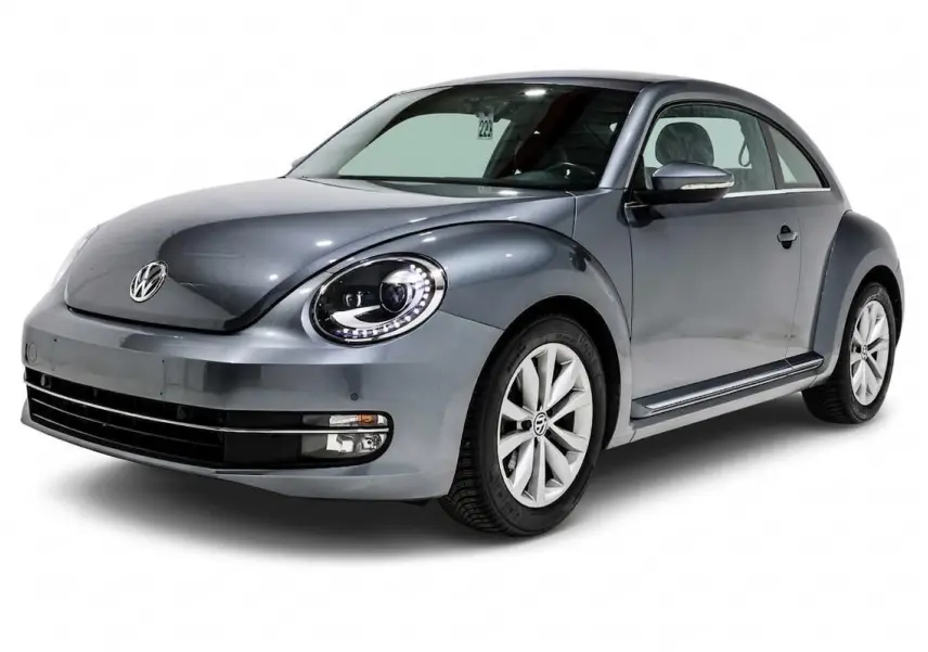 Volkswagen Coccinelle gris métallisé vue 3/4 avant droit avec phares LED et jantes alliage 16 pouces.