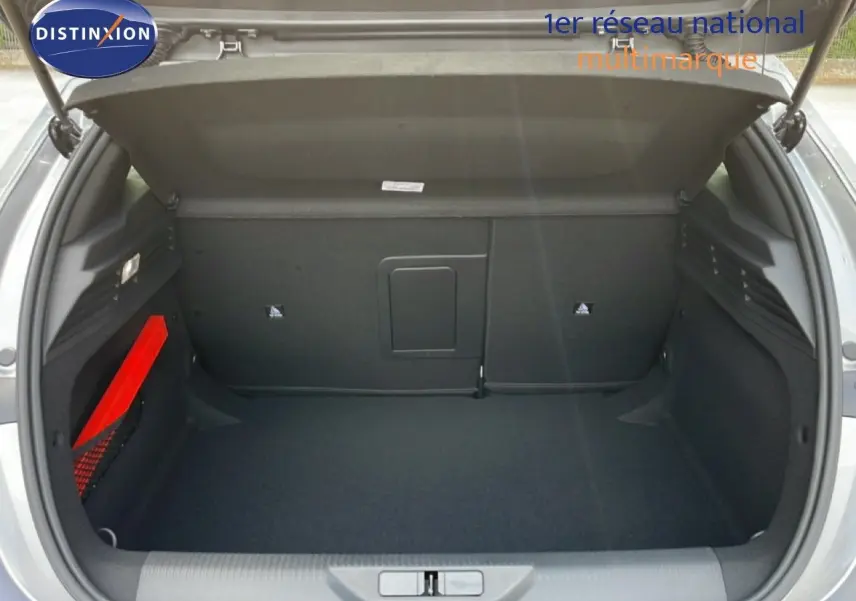 Coffre ouvert d'une Peugeot 308 gris Artense métal, vue de l'arrière montrant un espace de rangement propre et spacieux.