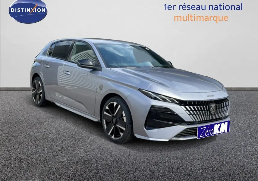 Peugeot 308 gris Artense métal vue 3/4 avant droit, avec calandre distinctive et jantes noires bicolores.