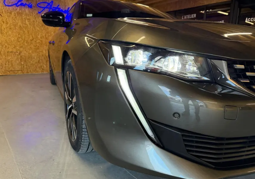 Vue 3/4 avant droit de la Peugeot 508 gris métallisé, mettant en valeur ses phares LED et jantes alu design.