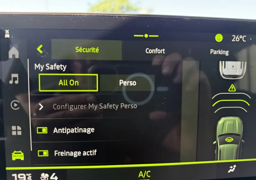 Écran tactile du tableau de bord du Dacia Duster Hybrid 155 Extreme montrant les réglages de sécurité et la température intérieure.