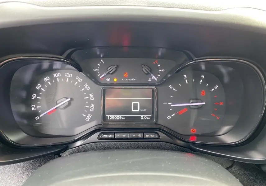 Vue rapprochée du tableau de bord du Citroën Berlingo blanc 2019, affichant le compteur et l'odomètre à 129009 km.