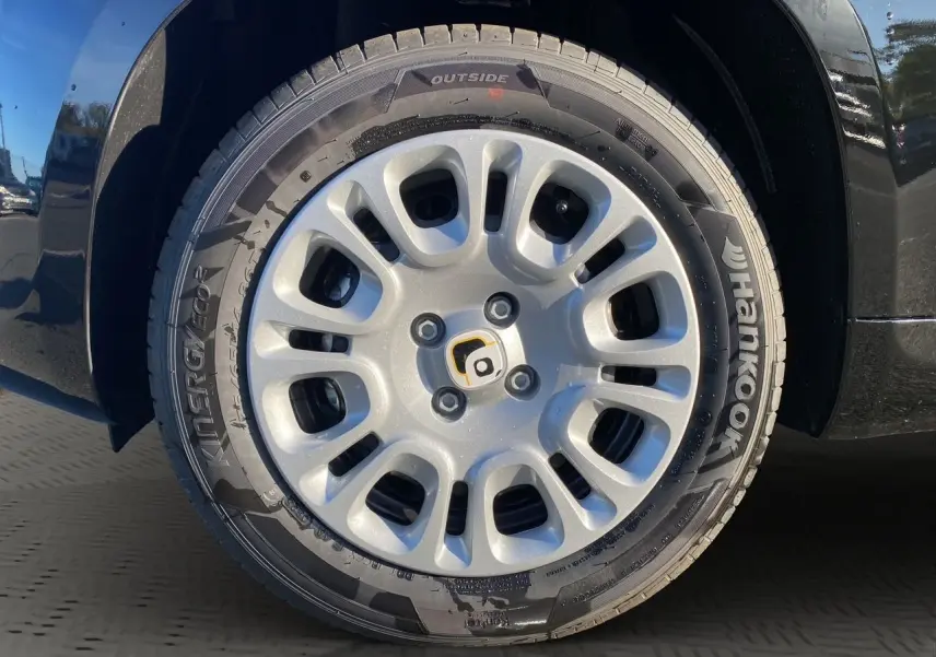 Gros plan sur la roue avant gauche noire de la Fiat Panda 2025 avec jante argentée et pneu Hankook.