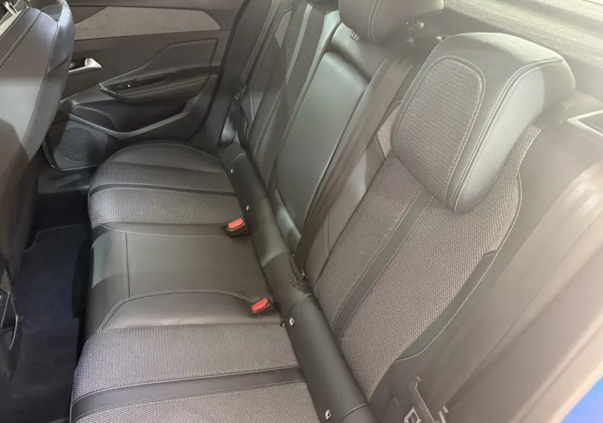 Vue côté droit de la banquette arrière en cuir et tissu gris de la Peugeot 308 PureTech 130 2023 bleu.