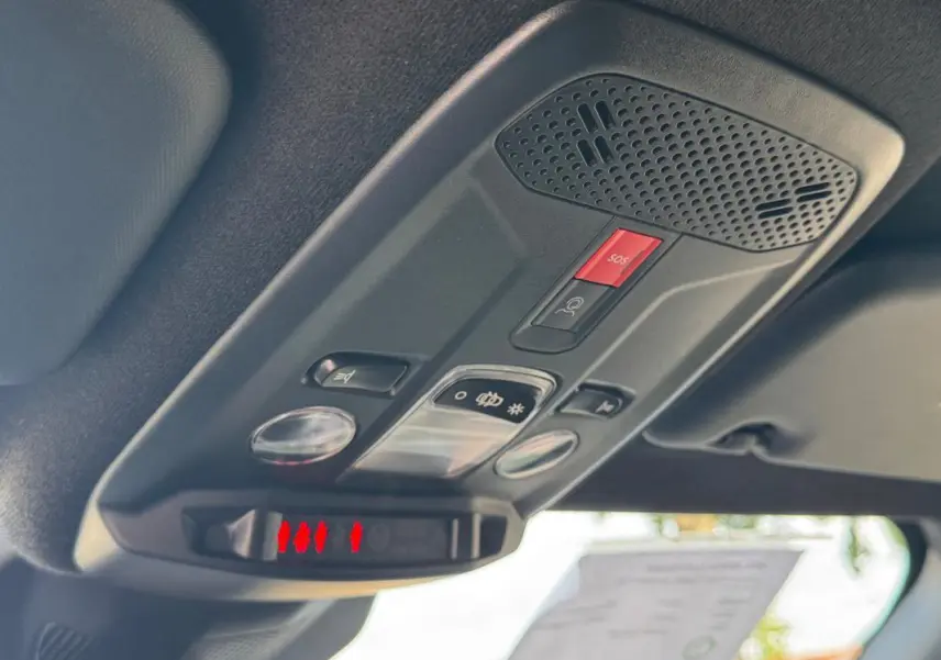 Vue intérieure en plongée sur le panneau de commandes au plafond du toit d’un Opel Mokka électrique gris 2025.
