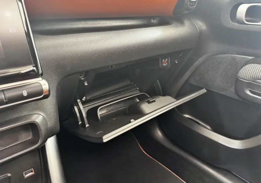 Vue intérieure côté passager du coffre à gants ouvert dans une Citroën C3 Aircross noire de 2020.
