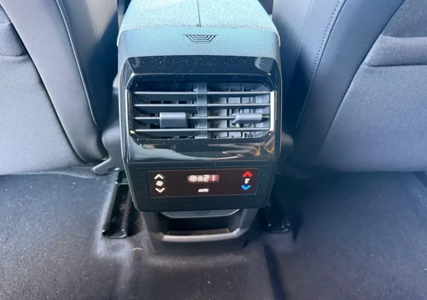 Vue rapprochée de la console arrière avec ventilation et commandes de climatisation du Peugeot 5008 gris Artense 2025.