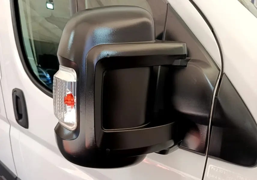 Gros plan sur le rétroviseur droit noir du FIAT Ducato Fourgon blanc, avec clignotant intégré visible.