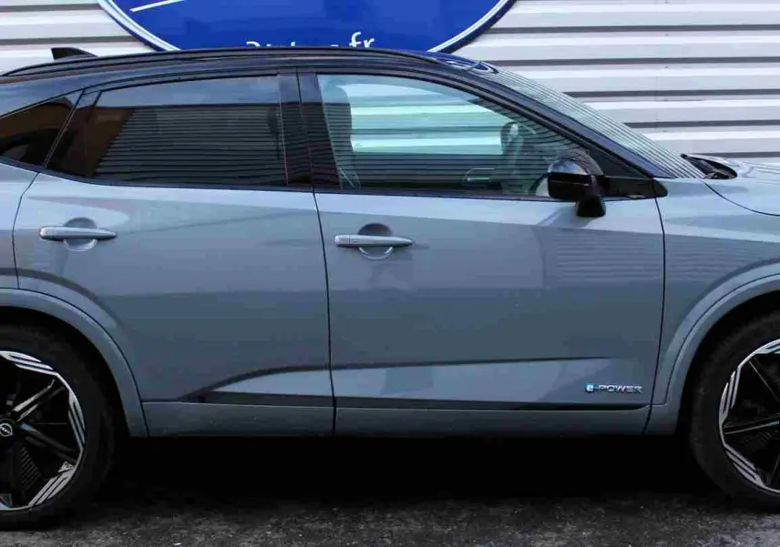 Vue rapprochée du tableau de bord numérique du Nissan Qashqai gris céramique avec affichage de navigation et compteurs digitaux.