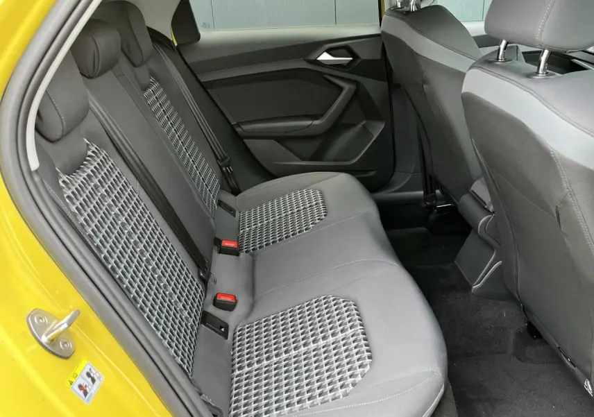 Vue intérieure arrière droite des sièges arrière gris à motifs de l'Audi A1 Allstreet jaune Python.