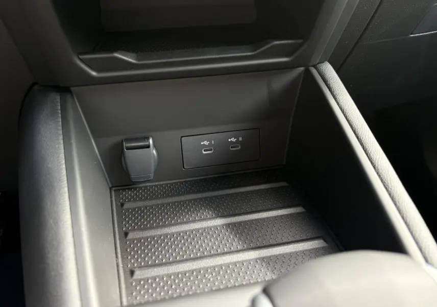 Gros plan sur la console centrale noire du Renault Symbioz 2025, montrant les ports USB-C et prise 12V intégrés.