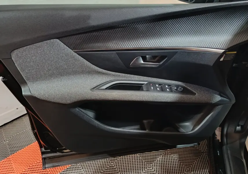 Vue rapprochée de la porte avant gauche du Peugeot 3008 2020, avec garniture grise et commandes électriques.