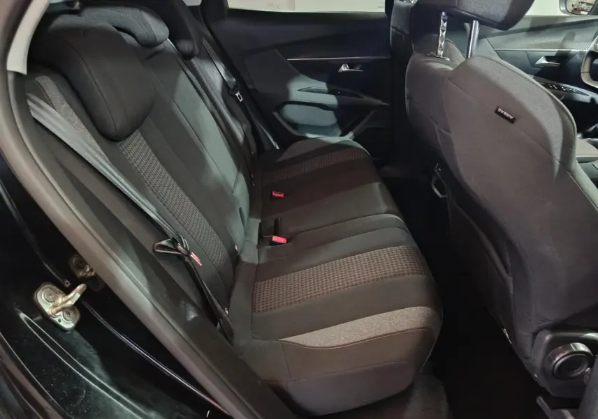 Vue côté gauche de la banquette arrière noire et grise du Peugeot 3008 2020 avec appuie-tête et ceintures visibles.