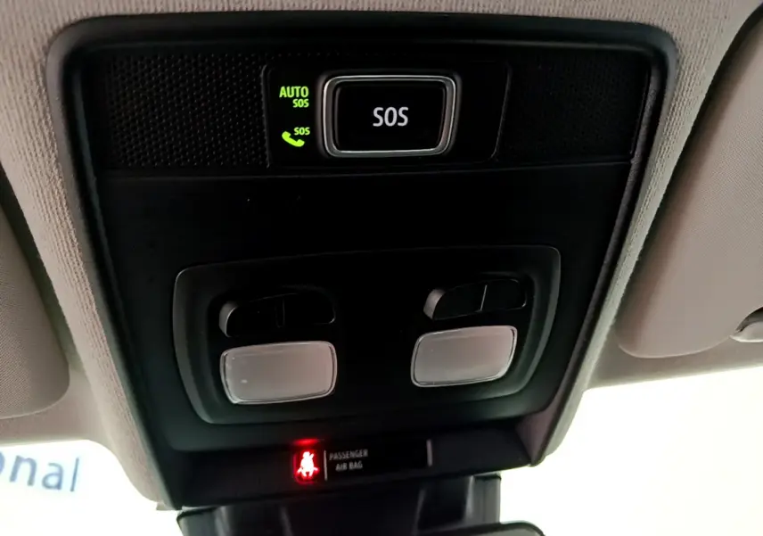 Vue en gros plan du plafonnier avec bouton SOS et voyants d'airbag dans l'habitacle d'une Renault Clio blanche 2020.