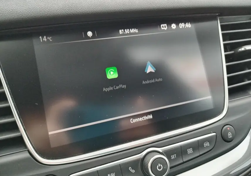Écran tactile central affichant Apple CarPlay et Android Auto dans l'habitacle d'un Opel Grandland X gris platinium.