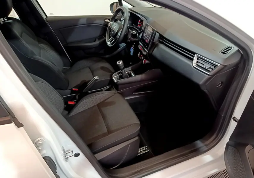 Intérieur de la Renault Clio Business Blue dCi 85 blanc, vue côté conducteur avec tableau de bord et sièges noirs.