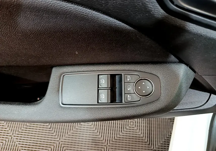 Panneau de commandes des vitres et rétroviseurs côté conducteur d'une Renault Clio Business Blue dCi 85 blanche de 2020.