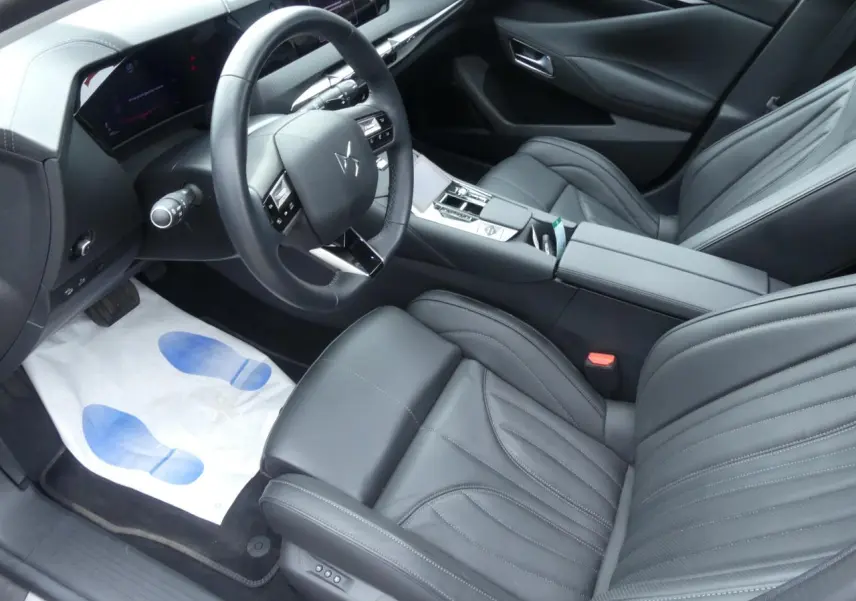 Vue intérieure côté conducteur du DS4 2024 avec sièges en cuir noir et tableau de bord moderne intégrant écran tactile.