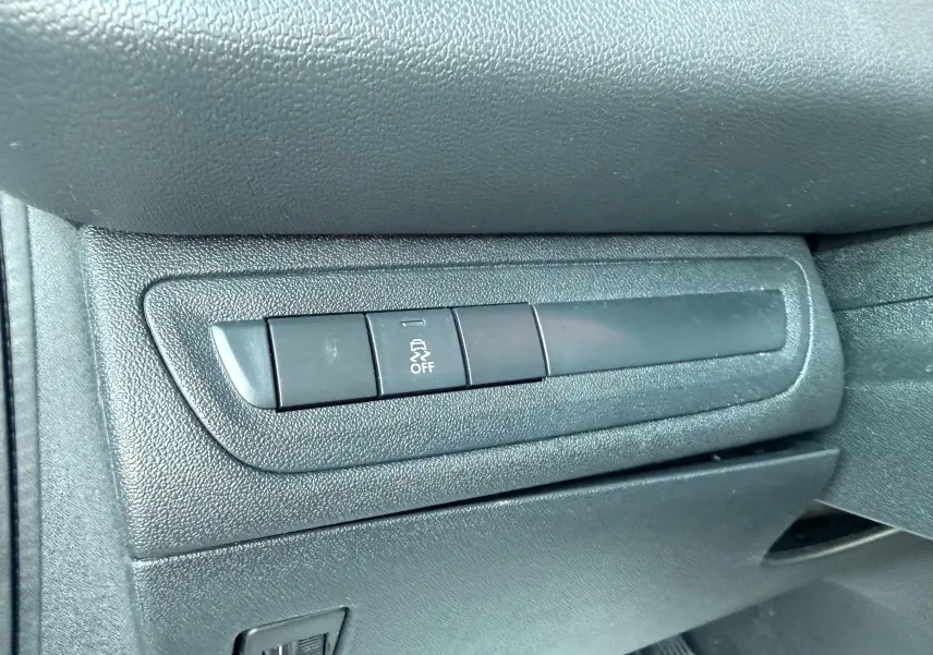 Détail intérieur montrant les boutons de contrôle de la Peugeot 208 1.4 HDi 70ch Active, finition noire texturée.
