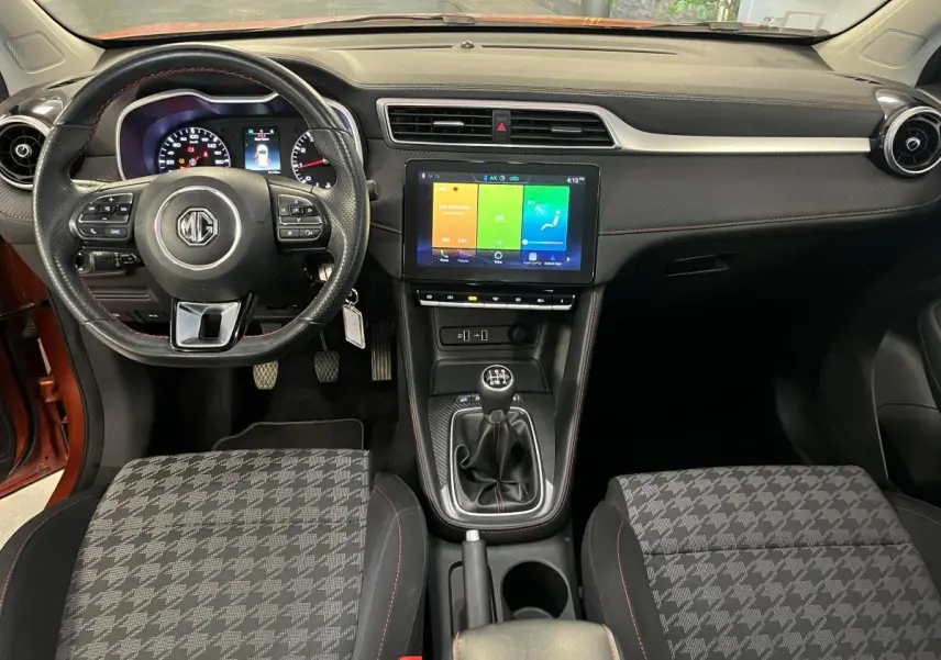 Intérieur MG ZS 2022 vu de face, volant cuir avec commandes, écran tactile 10,1 pouces et levier de vitesses manuel.