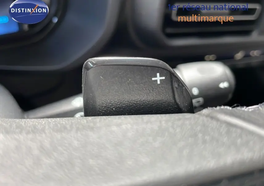 Gros plan sur la palette de changement de vitesse droite du volant dans l'habitacle du Citroën Berlingo gris 2026.