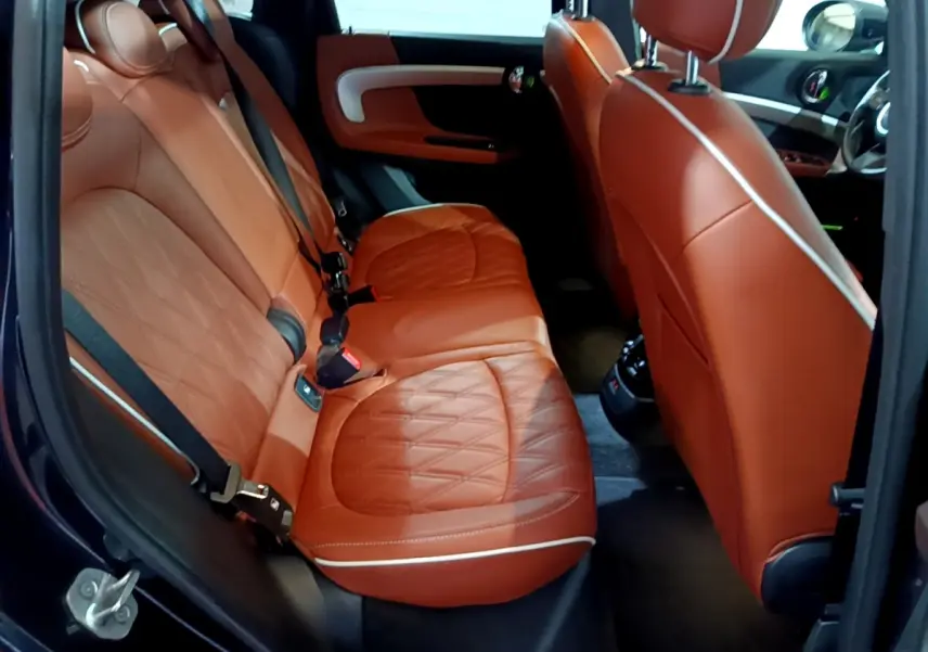 Vue intérieure côté gauche sur les sièges arrière en cuir marron du MINI Countryman Cooper SE 2021.
