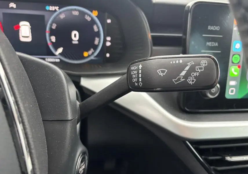 Gros plan sur la manette d'essuie-glace côté droit du tableau de bord d'une Skoda Kamiq 2024 gris graphite.