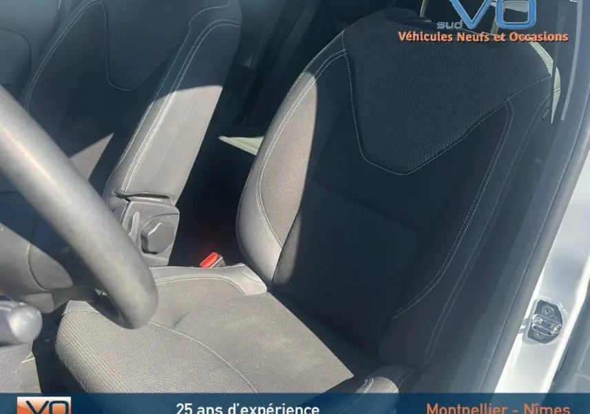 Siège conducteur en tissu noir de la Renault Clio IV Estate Business blanc, vue intérieure côté gauche avec volant partiel visible.