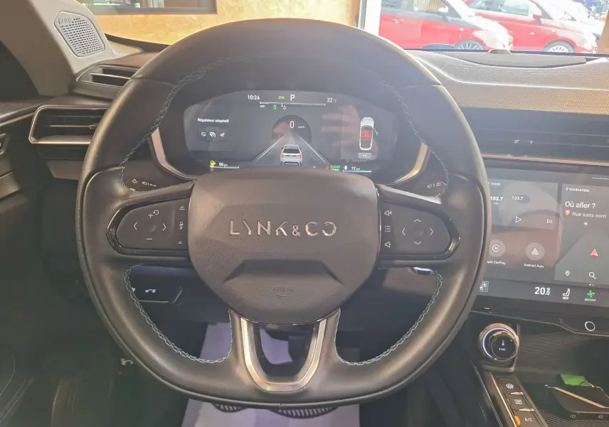 Vue rapprochée du volant noir de la Lynk & Co 01 PHEV 2022 avec tableau de bord numérique et écran tactile.