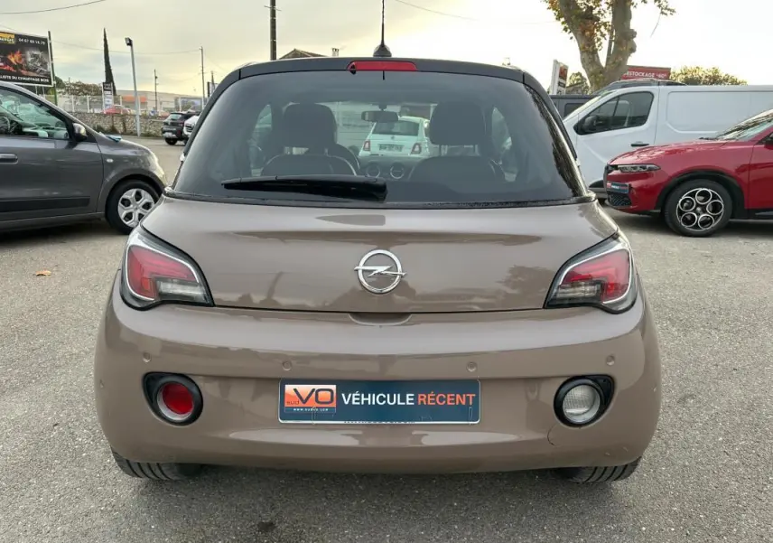 Vue arrière d'une Opel Adam marron 2016 avec feux distinctifs et plaque d'immatriculation "Véhicule récent" visible.