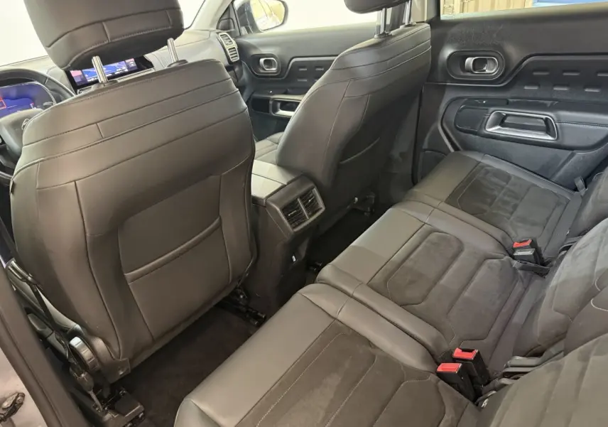 Vue intérieure arrière du Citroën C5 Aircross gris clair, sièges individuels en cuir et alcantara avec console centrale et aérateurs.