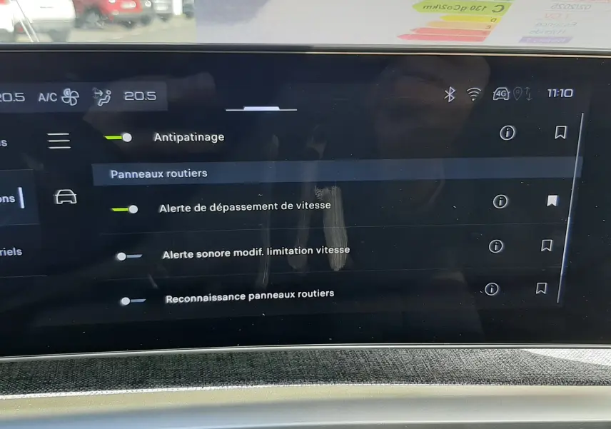 Vue rapprochée de l'écran tactile intérieur du Peugeot 5008 gris titane, affichant les réglages d'alerte et d'assistance à la conduite.