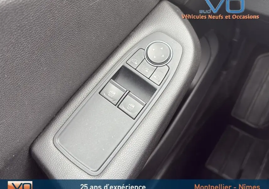 Gros plan sur les commandes des vitres électriques et rétroviseurs du côté conducteur d'une Renault Clio gris foncé V Blue dCi 85 Business 2020.