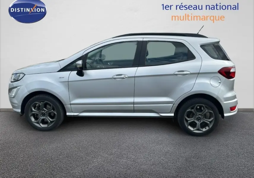 Vue latérale droite d'un Ford EcoSport gris clair 2018 avec jantes alliage 17 pouces et barres de toit noires.