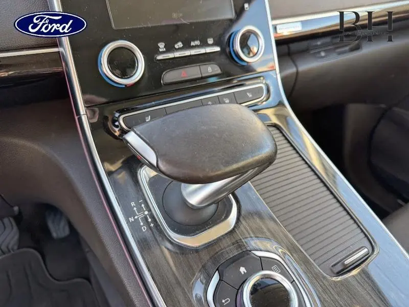 Le levier de vitesse automatique en cuir noir dans l'habitacle d'un Renault Espace gris Cassiopée, vue rapprochée côté console centrale.