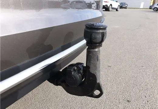 Gros plan sur l'attelage arrière noir d'une Audi A4 Avant Business gris Terra, visible côté gauche du pare-chocs.