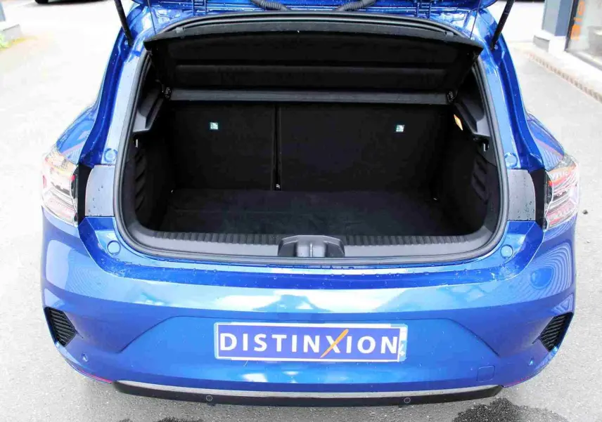 Gros plan sur la roue avant droite d'une Renault Clio bleu iron metal avec jante alliage bicolore moderne.