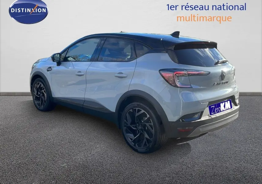 Renault Captur E-Tech hybride gris Rafale toit noir, vue 3/4 arrière côté gauche, jantes noires distinctives.