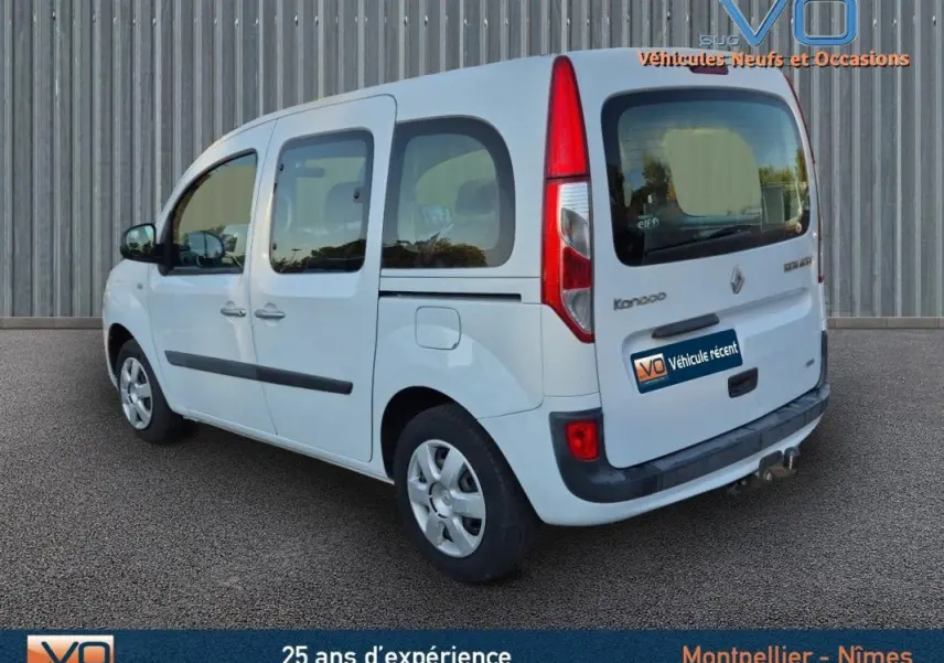Vue 3/4 arrière droite du Renault Kangoo blanc 2016 avec porte latérale et vitres surteintées.