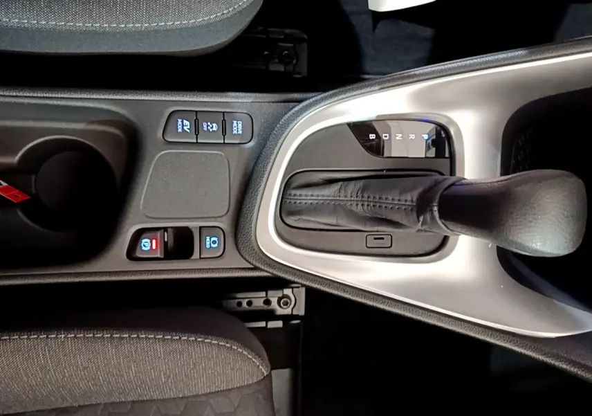 Gros plan sur la console centrale de la Toyota Yaris hybride 2021, avec levier de vitesse automatique et boutons de contrôle.