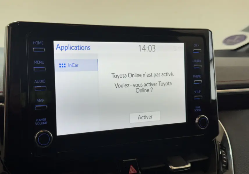 Écran tactile central allumé du tableau de bord de la Toyota Corolla Hybride 122h Collection 2021, intérieur noir.