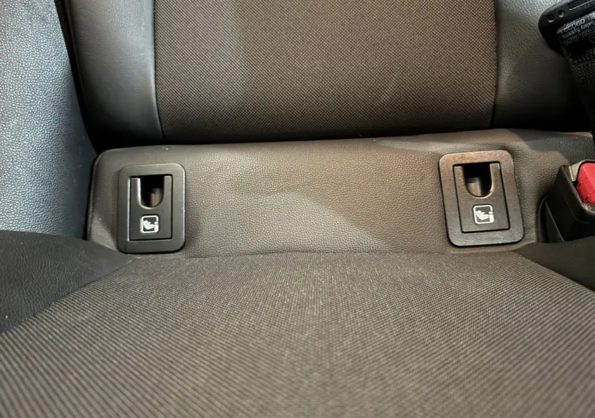 Gros plan sur les fixations Isofix noires sur la banquette arrière grise de la Toyota Corolla Hybride 122h Collection 2021.