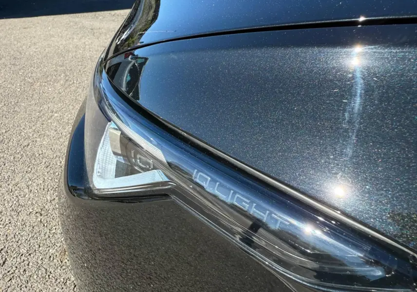 Gros plan sur le phare avant droit noir grenadilla métallisé avec inscription IQ.LIGHT sur une Volkswagen Golf 2024.