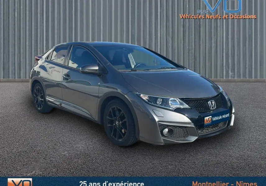Vue 3/4 avant gauche d'une Honda Civic gris métallisé 2015 avec jantes alliage noires et vitres surteintées.