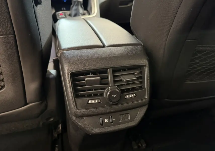 Vue rapprochée des aérateurs arrière et prise 12V noirs entre les sièges noirs du Peugeot 5008 bleu 2019.
