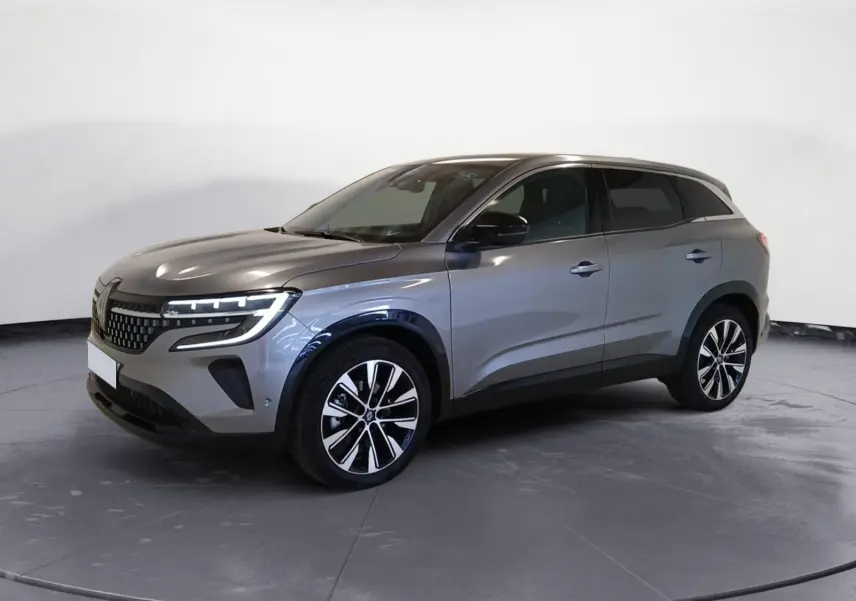 Renault Austral E-Tech 2024 gris métallisé en vue 3/4 avant droit avec jantes alliage noires et phares LED.